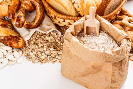 Flour on paper bag and oat flakes spilling from the burlap bag の写真素材