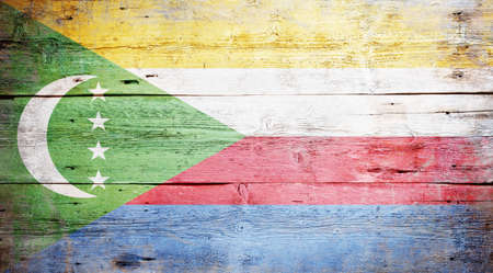 Flag of Comoros painted on grungy wood plank backgroundの写真素材
