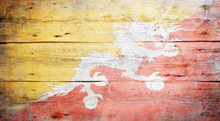 Flag of Bhutan painted on grungy wood plank backgroundの写真素材