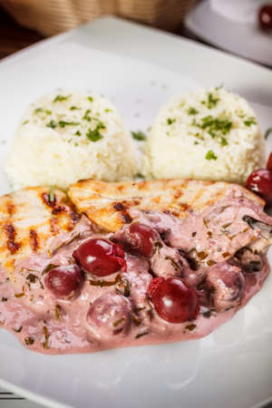 Grilled chicken breast with sour cherry sauceの写真素材