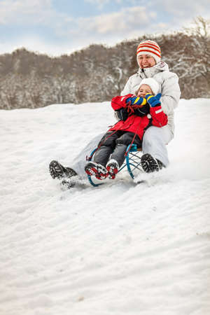 Winter fun, sledding at winter time の写真素材