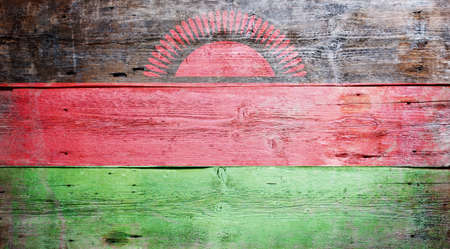 Flag of Malawi painted on grungy wood plank backgroundの写真素材