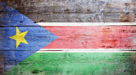Flag of South Sudan painted on grungy wood plank backgroundの写真素材