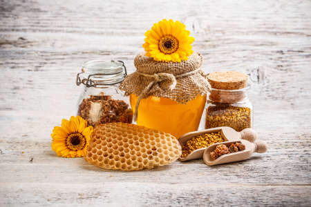 Combs, honey, pollen and propolis decorated with flowerの写真素材