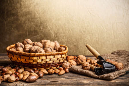 Basket of walnuts on rustic wooden board の写真素材