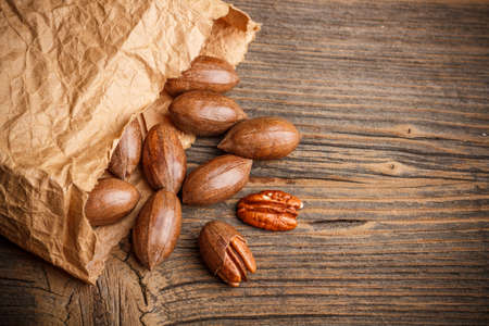 Organic fresh harvested pecan nut in paper sackの写真素材