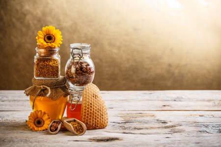 Decorative display with jars of fresh honey, flower pollen and propolis