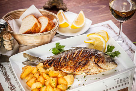Dorado fish served on restaurant tableの写真素材