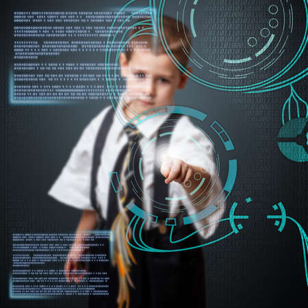 Little boy in daddy business suit using technologies of the futureの写真素材