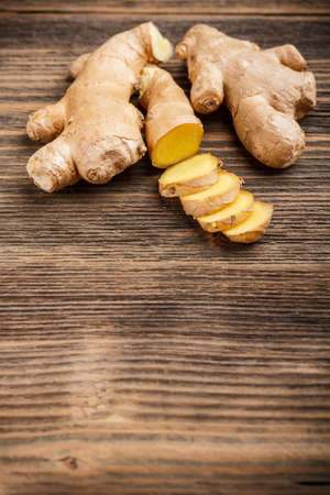 Fresh ginger root on wooden backgroundの写真素材