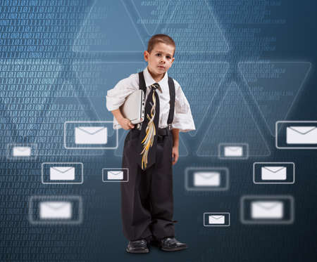 Email concept with little business boy dressed in oversized suit clothes の写真素材