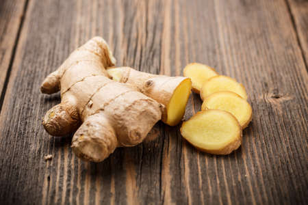 Ginger root sliced on wooden tableの写真素材