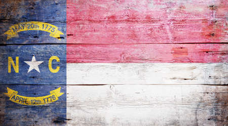 Flag of the state of North Carolina painted on grungy wooden backgroundの写真素材