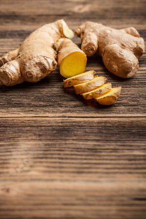 Ginger root sliced on wooden tableの写真素材