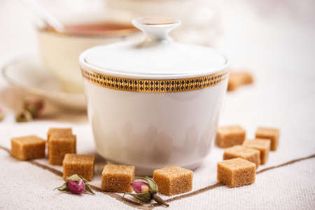 Porcelain sugar bowl with brown lump sugarの写真素材