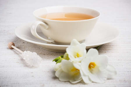 Closeup of cup of tea with freesiaの写真素材