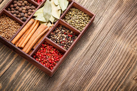 Wooden box with different spicesの写真素材