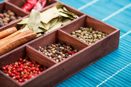 Assortment of spices in a wooden boxの写真素材