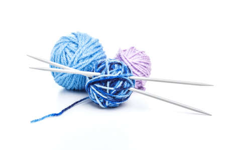 Knitting needles and a balls of wool on a white