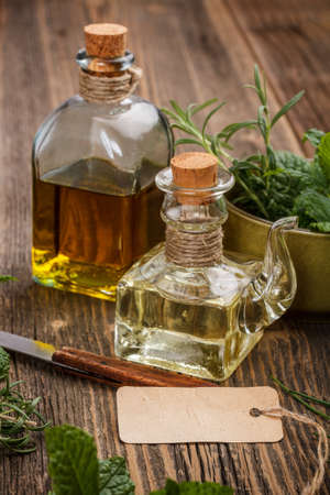 Glass bottle of olive oil with a paper labelの写真素材