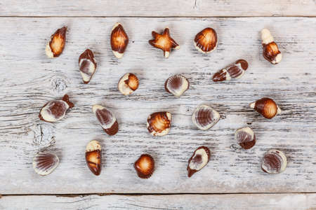 Chocolate sweets on old wooden background