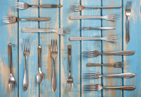Set of forks on painted blue wooden boardの写真素材