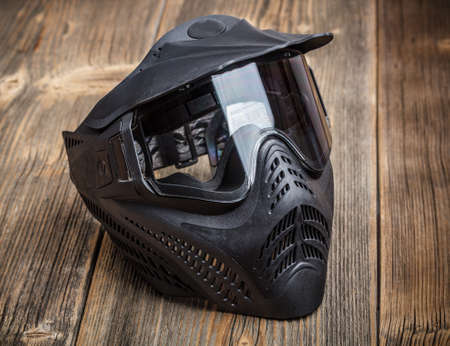 Paintball mask on rustic wooden backgroundの写真素材