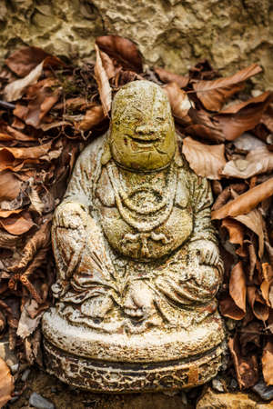 Garden sculpture with fat statue Buddhaの写真素材