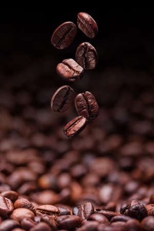 Falling brown roasted coffee beans の写真素材