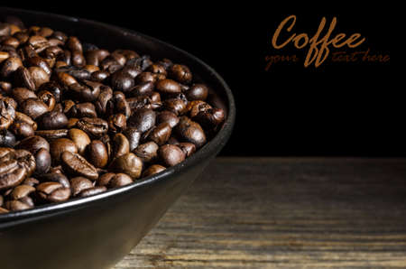 Roasted coffee beans in plateの写真素材