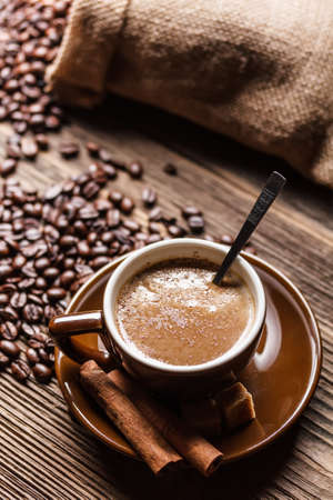 Warm cup of coffee on rustic wooden tableの写真素材