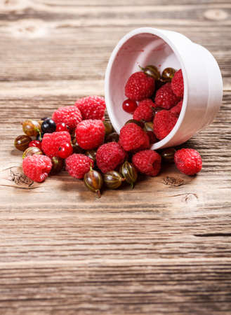 Mixed berries scattered on wooden table