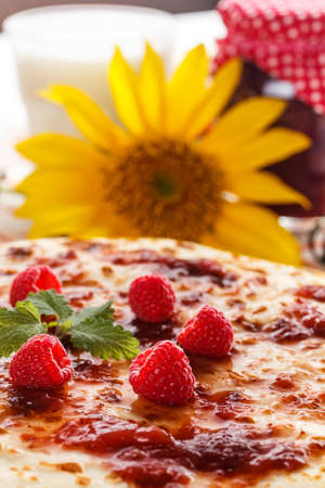 Fresh cooked pancakes topped with raspberries jam