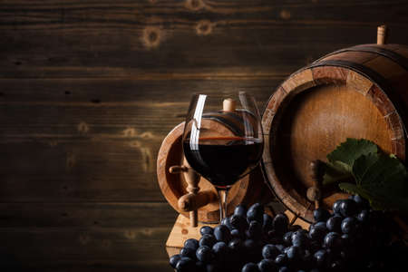 Wine concept with glass, grape fruit and barrelの写真素材