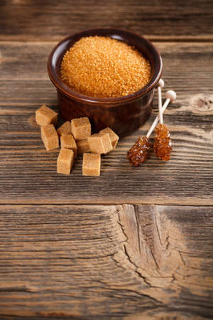 Brown sugar on old wooden backgroundの写真素材