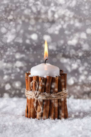 Christmas candle decorated with cinnamonの写真素材