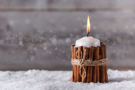  Christmas candle decorated with cinnamonの写真素材