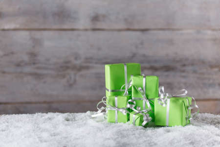 Christmas gifts in snow with space for textの写真素材
