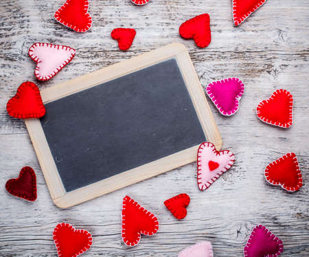 Chalkboard with felt hearts used as a symbol of loveの写真素材