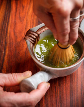 Tea master make matcha tea with tea whisk