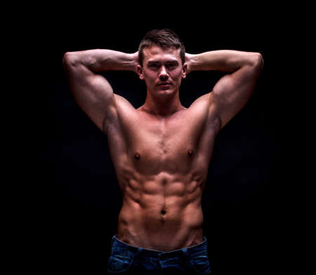 Male model in stylish jeans with muscular body
