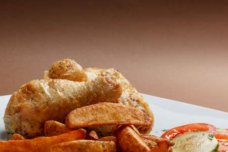 Close up of roasted chicken legs with potatoesの写真素材