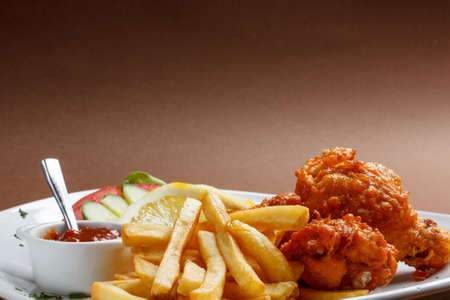 Spicy breaded chicken legs with potatoの写真素材