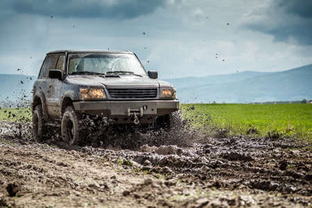Off-road vehicle splashed mud の写真素材