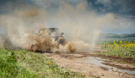 Off road jeep in mud and dirt splashの写真素材