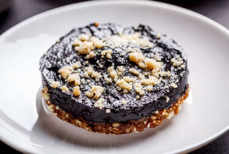 Almond cakes  with chocolate on white plateの写真素材