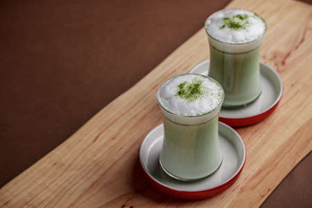 Matcha latte in glass with foamの写真素材