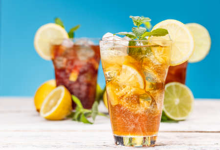 Glass of ice tea with lemon and mint leafの写真素材