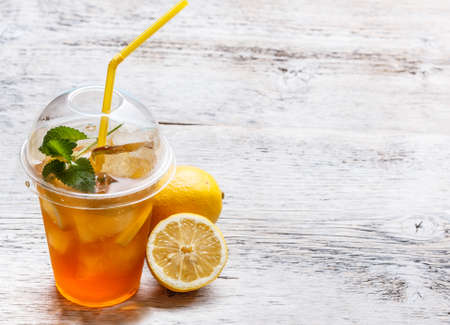 Fresh ice tea in plastic cupの写真素材