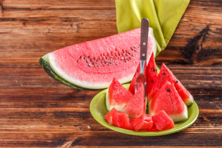 Slices of watermelon with fork on a plateの写真素材